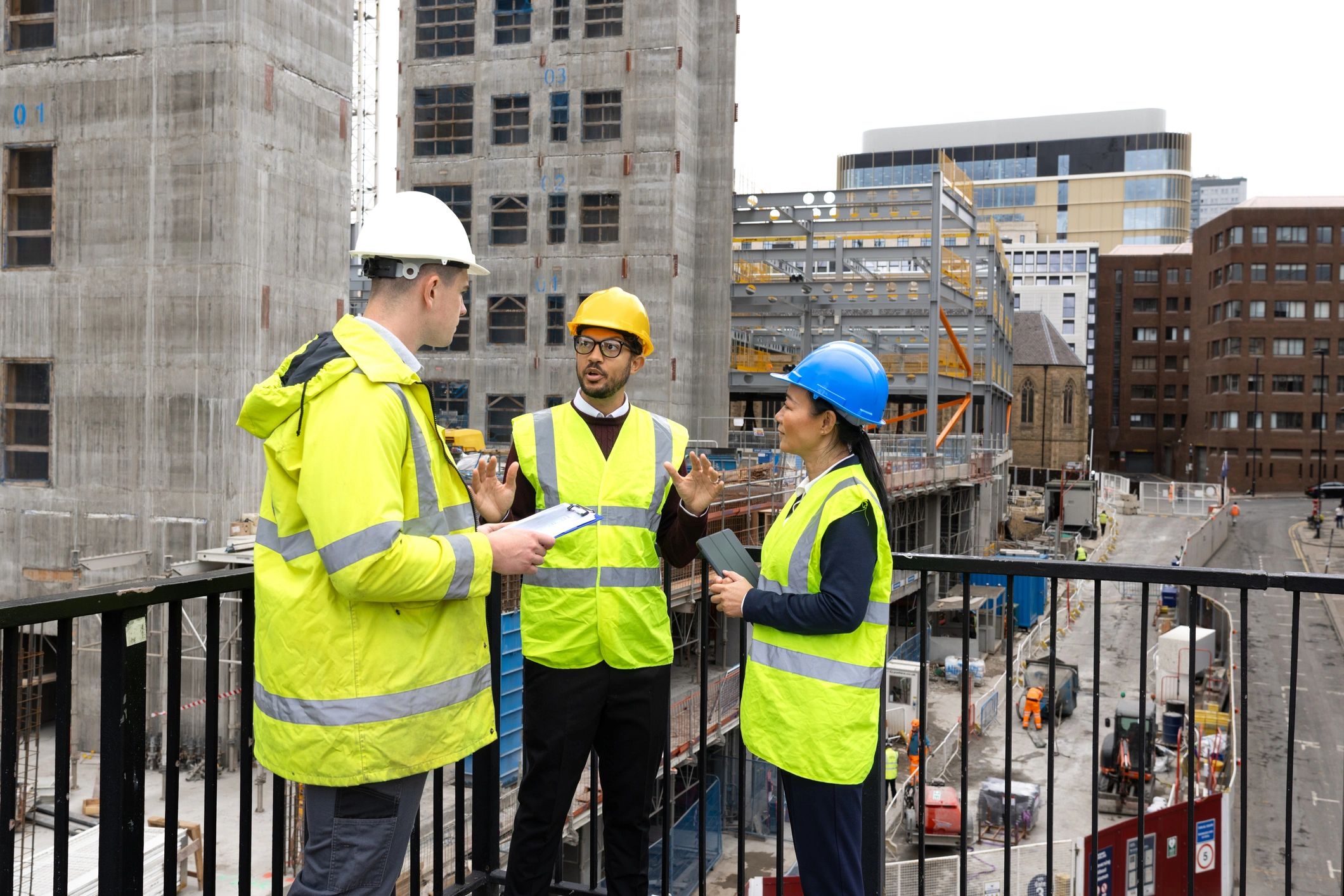 Field team reviewing plans and tablet at an infrastructure worksite